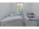 Laundry room with a washer and dryer, and a window with a view of the outside at 4367 Cedar Wood Sw Dr, Lilburn, GA 30047