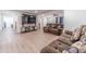 Open living room featuring hardwood floors and large-screen television at 4367 Cedar Wood Sw Dr, Lilburn, GA 30047