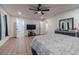 Spacious main bedroom featuring wood floors, ceiling fan, and a television for relaxing evenings at 4367 Cedar Wood Sw Dr, Lilburn, GA 30047