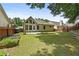 Well-maintained backyard featuring a green lawn, a cozy patio, and a charming vegetable garden at 4730 Fairway View Ct, Duluth, GA 30096
