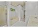 Bright bathroom features a tub, standing shower, and a double sink at 4730 Fairway View Ct, Duluth, GA 30096