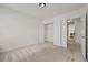 Cozy bedroom features neutral carpet, closet, and doorway to the kitchen at 4730 Fairway View Ct, Duluth, GA 30096