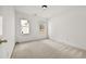 Cozy bedroom featuring neutral carpet, two bright windows, and white walls at 4730 Fairway View Ct, Duluth, GA 30096