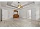 Large bedroom features neutral carpet, tray ceiling with fan, and light wood dresser at 4730 Fairway View Ct, Duluth, GA 30096