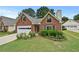Inviting brick home boasting a neat lawn and colorful flower beds at 4730 Fairway View Ct, Duluth, GA 30096