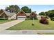 Lovely brick home featuring a well-maintained lawn and established landscaping at 4730 Fairway View Ct, Duluth, GA 30096