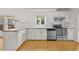 Spacious kitchen featuring wood countertops, stainless steel appliances and white cabinets at 4730 Fairway View Ct, Duluth, GA 30096