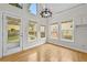 Bright kitchen and dining area with backyard views and featuring a modern chandelier at 4730 Fairway View Ct, Duluth, GA 30096