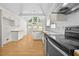 Bright kitchen features white cabinetry, vaulted ceilings, and access to the backyard at 4730 Fairway View Ct, Duluth, GA 30096
