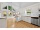 Bright kitchen with backyard view, white cabinets, stainless steel appliances, and laminate flooring at 4730 Fairway View Ct, Duluth, GA 30096