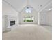 Bright and airy living room with a fireplace, vaulted ceiling, and ample windows at 4730 Fairway View Ct, Duluth, GA 30096
