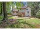 Expansive backyard with mature trees, a deck, and a patio at 946 Cornwall Sw Ct, Marietta, GA 30064