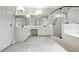 Bathroom featuring a frameless shower, double sinks, white cabinets, and unique tile flooring at 946 Cornwall Sw Ct, Marietta, GA 30064