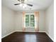 Minimalist bedroom with wood flooring, a ceiling fan, and a large window at 946 Cornwall Sw Ct, Marietta, GA 30064
