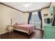 Cozy bedroom with dark wood floors, a ceiling fan, and a window with blue curtains at 946 Cornwall Sw Ct, Marietta, GA 30064