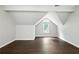 Attic bedroom featuring hardwood floors, an arched window, and neutral gray paint at 946 Cornwall Sw Ct, Marietta, GA 30064