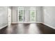 Bright empty room with hardwood floors and two windows at 946 Cornwall Sw Ct, Marietta, GA 30064