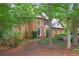 Charming two-story brick home with a well-manicured lawn and mature trees at 946 Cornwall Sw Ct, Marietta, GA 30064