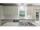 Bright kitchen featuring white cabinetry, stainless steel appliances, and a gas cooktop at 946 Cornwall Sw Ct, Marietta, GA 30064