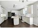 Kitchen featuring white cabinets, stainless steel appliances, a large island, and hardwood floors at 946 Cornwall Sw Ct, Marietta, GA 30064
