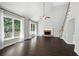 Bright living room featuring hardwood floors, fireplace, ceiling fan, and large windows with natural light at 946 Cornwall Sw Ct, Marietta, GA 30064