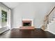 Inviting living room with a brick fireplace, hardwood floors and a staircase leading to the upper level at 946 Cornwall Sw Ct, Marietta, GA 30064