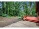 Landscaped backyard with deck, patio, and lush trees for privacy at 1094 Seville Dr, Clarkston, GA 30021