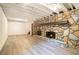 Spacious finished basement area featuring a stone fireplace at 1094 Seville Dr, Clarkston, GA 30021