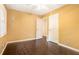 Sunny bedroom showcases hardwood floors and bright yellow walls at 1094 Seville Dr, Clarkston, GA 30021