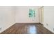 Bright bedroom featuring beautiful hardwood floors, a large window, and a closet at 1094 Seville Dr, Clarkston, GA 30021