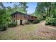 Exterior view of a two-story brick house surrounded by lush greenery at 1094 Seville Dr, Clarkston, GA 30021