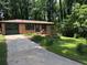 Charming brick home with a well-maintained lawn and attached garage at 1094 Seville Dr, Clarkston, GA 30021