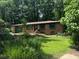 All-brick home with a neatly landscaped front yard, dark green trim, and an attached garage at 1094 Seville Dr, Clarkston, GA 30021