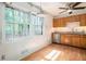 Eat-in kitchen with stainless steel appliances and large windows looking out onto the lush backyard at 1094 Seville Dr, Clarkston, GA 30021