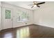Bright room with hardwood floors, white walls, ceiling fan and lots of natural light at 1094 Seville Dr, Clarkston, GA 30021