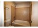 Bathroom with tiled shower/tub combo, toilet, and towel rack at 1105 Natchez Trce, Atlanta, GA 30350