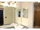 Bright bathroom featuring a large mirror, vanity, and a bathtub with tiled walls at 1105 Natchez Trce, Atlanta, GA 30350