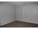 Empty bedroom with neutral walls, brown carpet, and a single window offering natural light at 1105 Natchez Trce, Atlanta, GA 30350