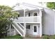 Exterior view of condo featuring white trim, steps, and nice landscaping at 1105 Natchez Trce, Atlanta, GA 30350