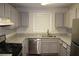 Kitchen features stainless appliances, granite countertops, and sleek cabinets at 1105 Natchez Trce, Atlanta, GA 30350