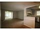 Open-concept living room with a sliding glass door, carpet and a view into the kitchen area at 1105 Natchez Trce, Atlanta, GA 30350