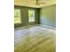 Spacious bedroom features light green walls and beautiful hardwood flooring at 191 Deerfield Ln, Carrollton, GA 30116
