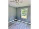 A cozy bedroom features gray walls, hardwood floors and a ceiling fan for a modern feel at 191 Deerfield Ln, Carrollton, GA 30116