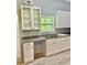 Well-equipped kitchen featuring granite countertops, white cabinets, and a convenient window view at 191 Deerfield Ln, Carrollton, GA 30116