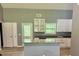 Bright kitchen with white cabinets, granite counters, and a spacious island, perfect for entertaining at 191 Deerfield Ln, Carrollton, GA 30116