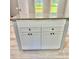 Kitchen island with white cabinets and granite countertop, offering storage and additional workspace at 191 Deerfield Ln, Carrollton, GA 30116