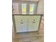 Stylish kitchen island featuring white cabinetry, a granite countertop, and modern fixtures at 191 Deerfield Ln, Carrollton, GA 30116