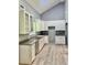 Well-lit kitchen featuring granite countertops, white cabinets, and ample storage space at 191 Deerfield Ln, Carrollton, GA 30116