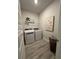 Laundry room with side by side washer and dryer, shelf and decorative painting at 3006 Fairway Dr, Villa Rica, GA 30180