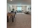 Neutral toned living room featuring an area rug, comfortable seating, and foosball table at 3006 Fairway Dr, Villa Rica, GA 30180